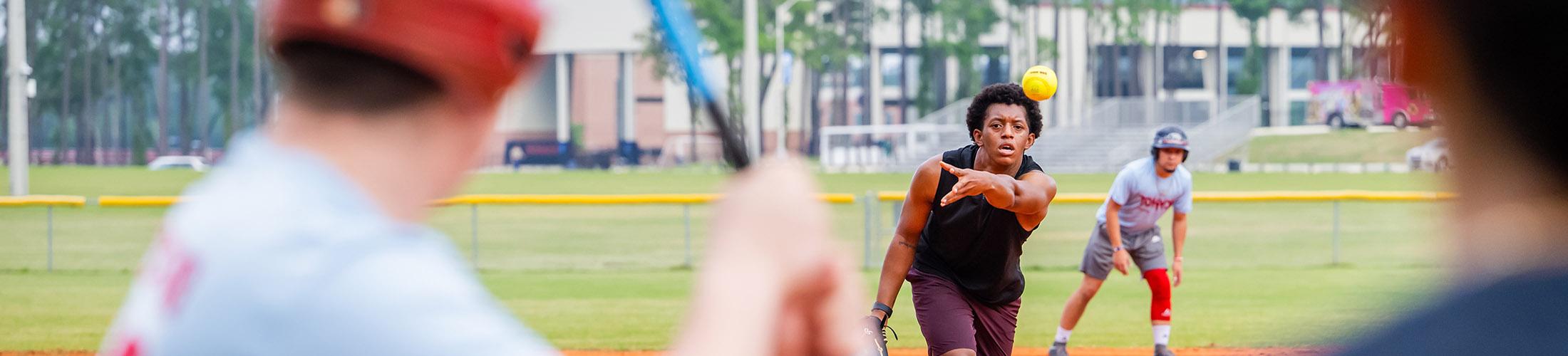 Students playing softball.